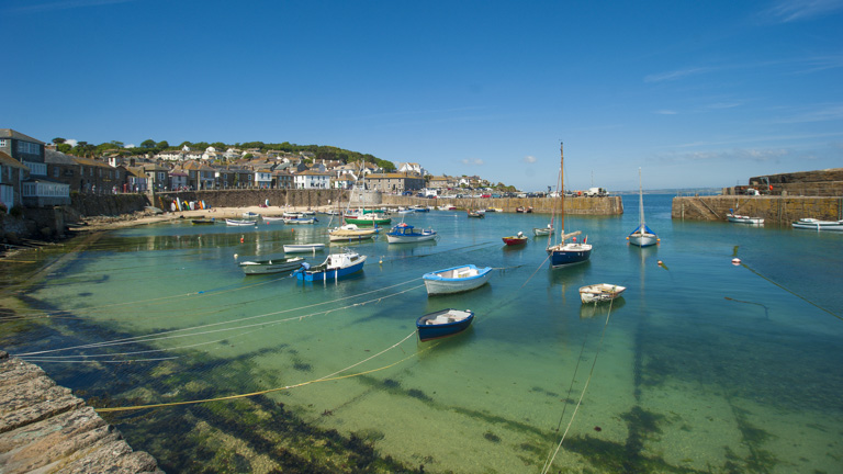 The beautiful Mousehole harbour in the sunshine on a summer's day