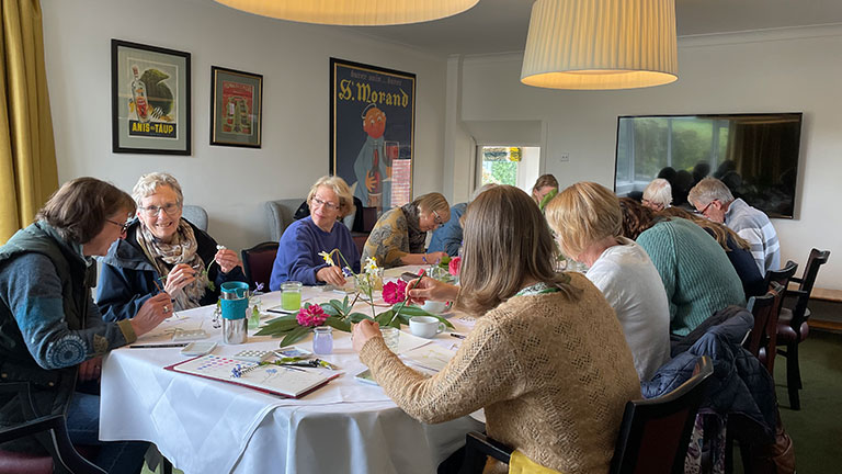 Everyone gathering around the table for the botanical watercolour workshop with Sarah Jane Humphrey