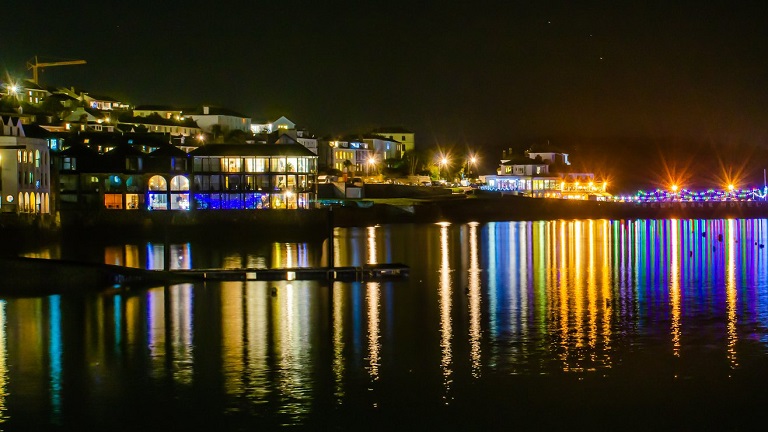 Christmas lights reflecting in the water during Falmouth's festive weekend