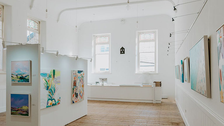 Inside the bright and airy gallery of the North Coast Asylum in North Cornwall, a former Gothic chapel converted into an art studio and gallery