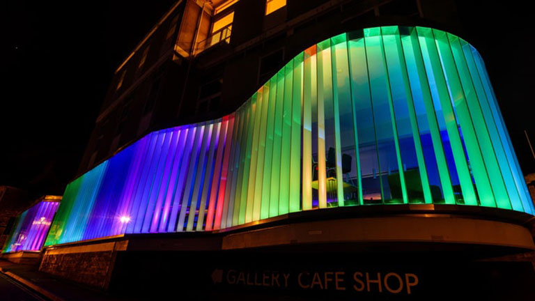 The exterior of the Exchange in Penzance brightly illuminated by multi-coloured lights