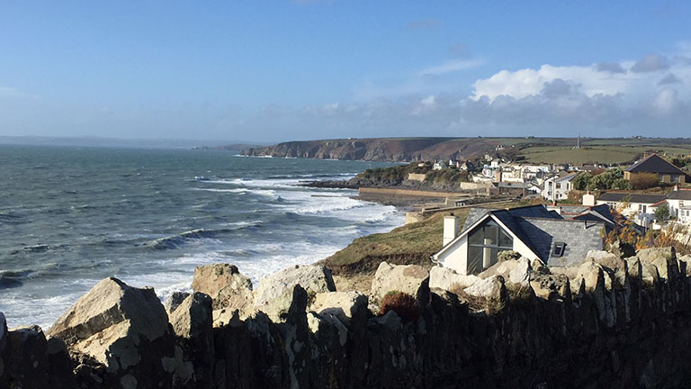 Reaching views over the town of Porthleven and a rolling blue sea