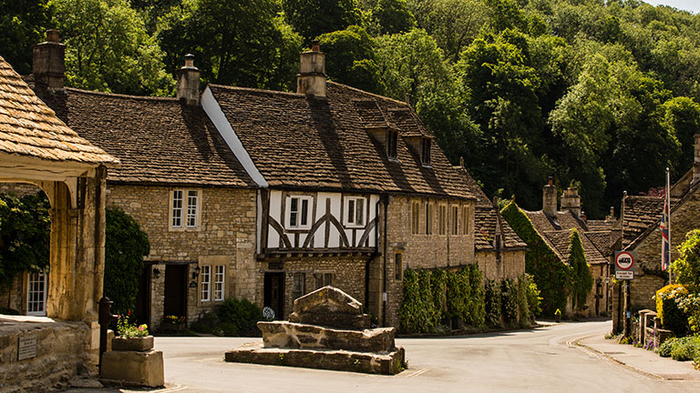 Historic houses and buildings with timber frames and Cotswolds stone in the village of Castle Combe in the Wiltshire Cotswolds