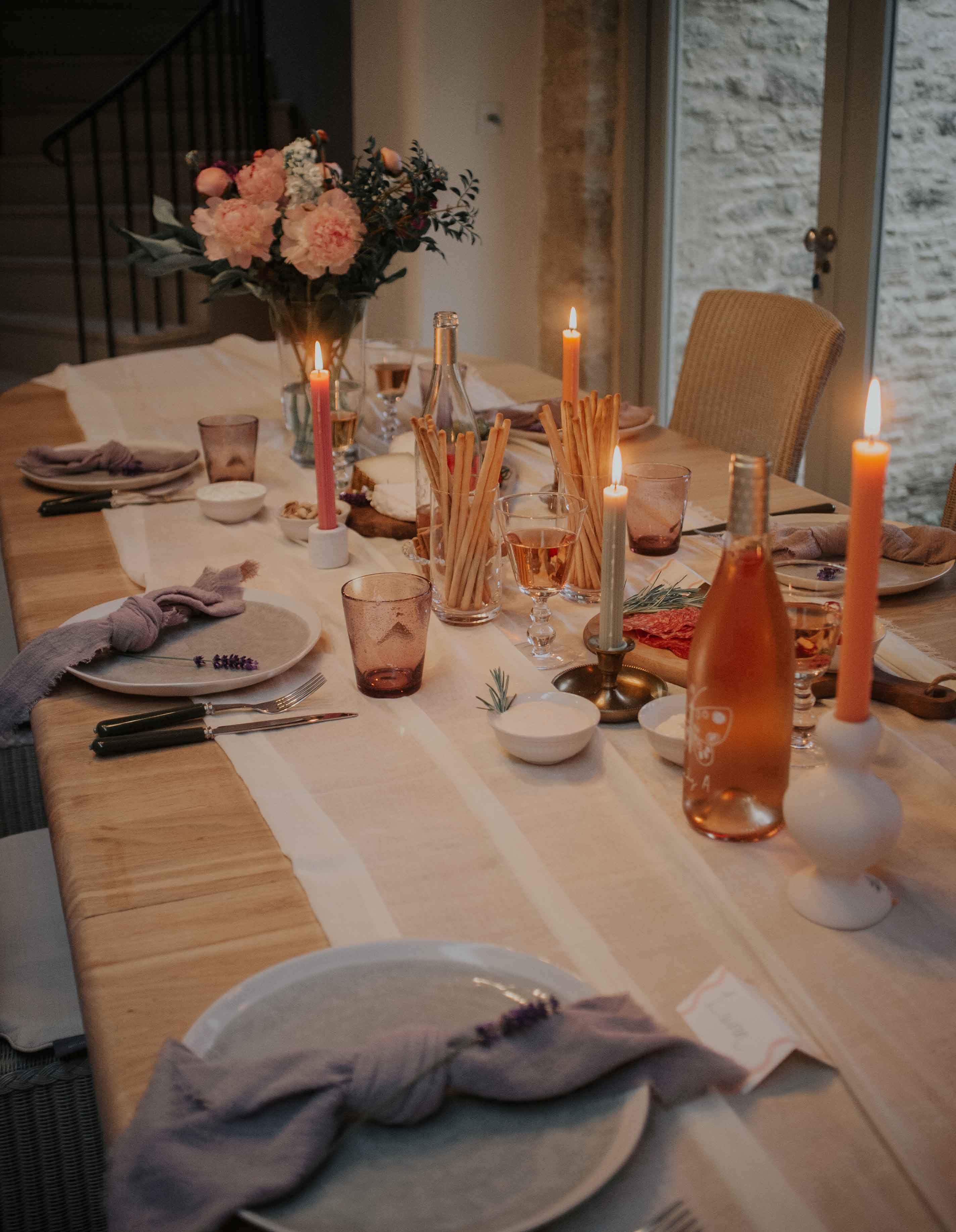 Lavender's dining table dressed for dinner and decorated with flowers and candles