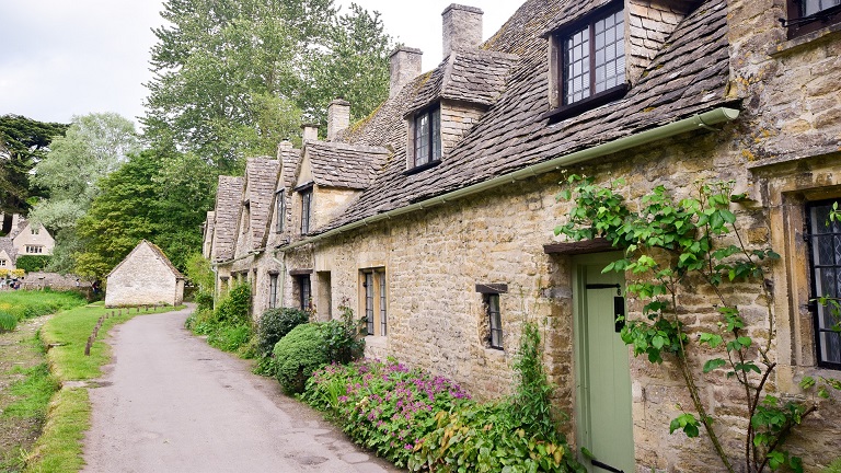 A row of traditional cottages in Bibury in the Gloucestershire Cotswolds