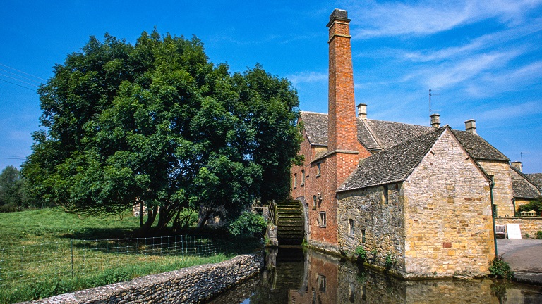The Old Mill and Museum by the river in the village of Lower Slaughter in the Gloucestershire Cotswolds