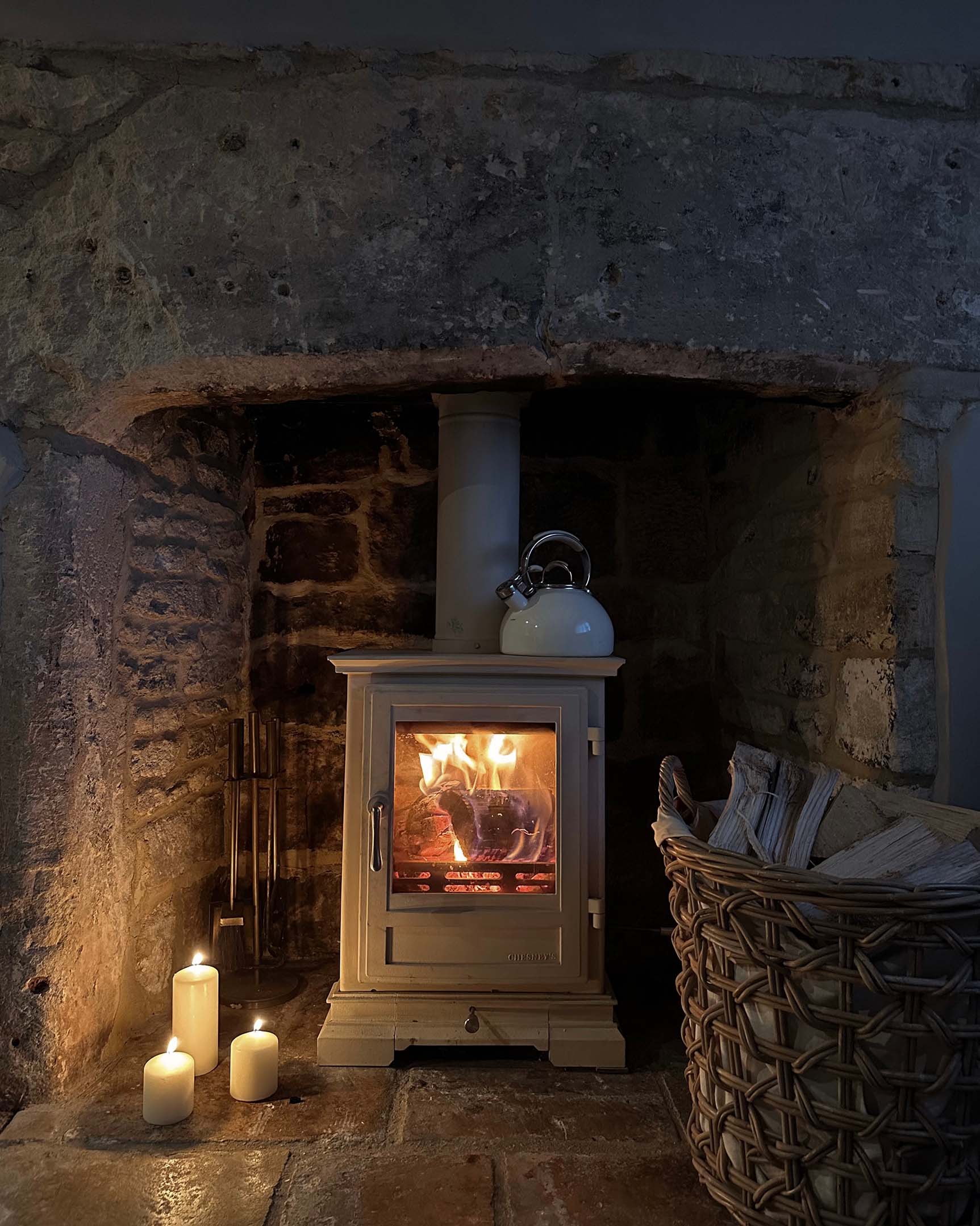 A fire glowing in Wool Cottage's wood burning stove