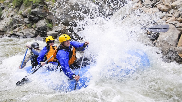 A group of paddlers take on the froth, white water rafting together