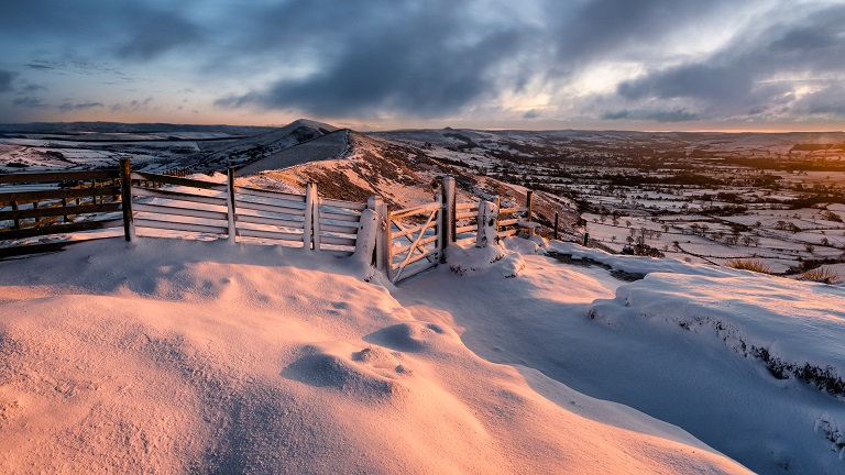 A beautiful Peak District sunrise over snow-covered hills