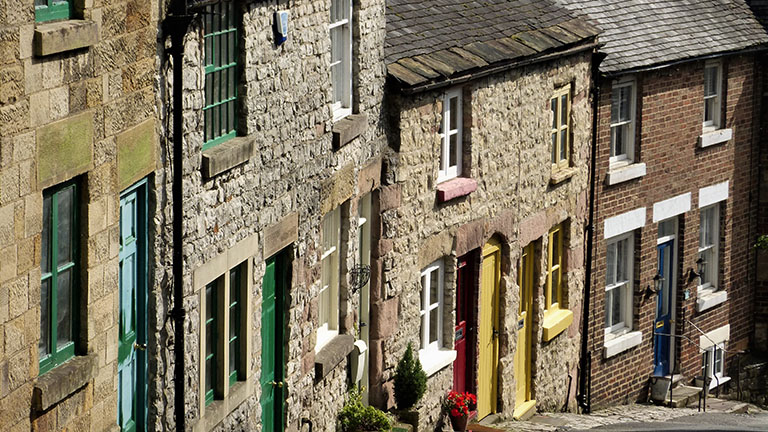 Houses with multi-coloured doorways on Green Hill in Wirksworth in the Derbyshire Dales