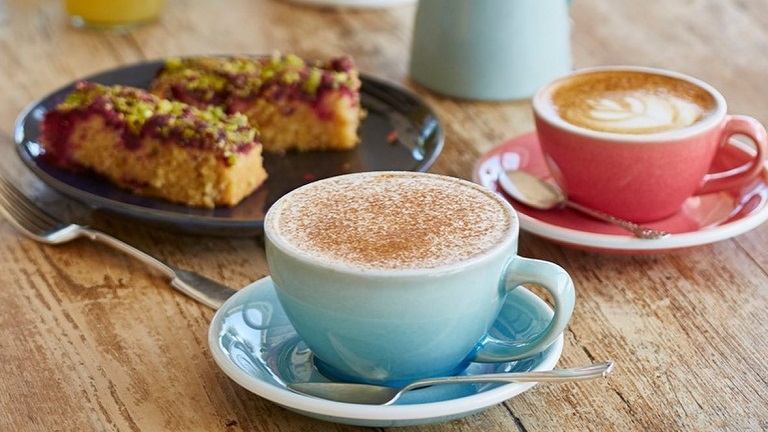 A selection of hot drinks and sweat treats served by Heron Valley orchard and farm's cafe in Loddiswell, Kingsbridge