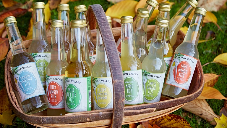A collection of drinks in bottles produced and made by Heron Valley farm and orchard in Devon