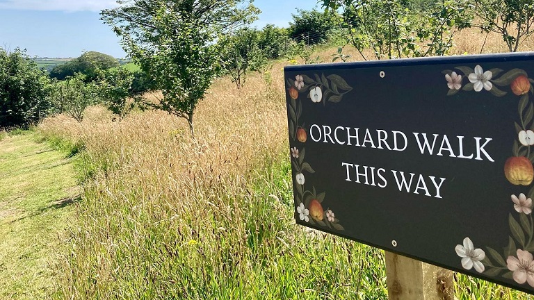 A signpost showing the way for the Heron Valley's orchard walk in Loddiswell, Kingsbridge, Devon