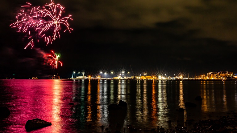 Fireworks exploding over Poole Harbour during Poole's Christmas Maritime Light Festival