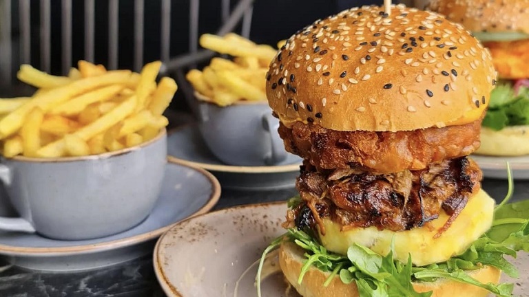 Stacked burgers and chips at the Dispensary Kitchen in Winchester