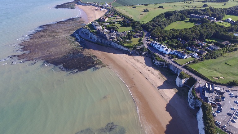 A bird's eye view of Kingsgate Beach in Kent taken from the sky and looking down onto the beach and clifftop houses
