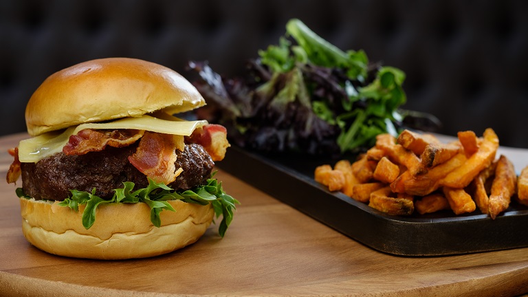 A fresh burger served with salad and chips | Places to eat in West Malling