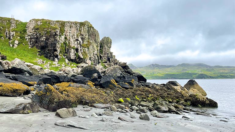 Sand, rocks, and impressive cliffs at An Corran Beach on the Isle of Skye