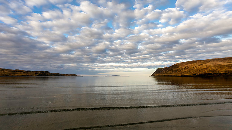 Beautiful flat waters at sunset at Glenbrittle Beach on the Isle of Skye