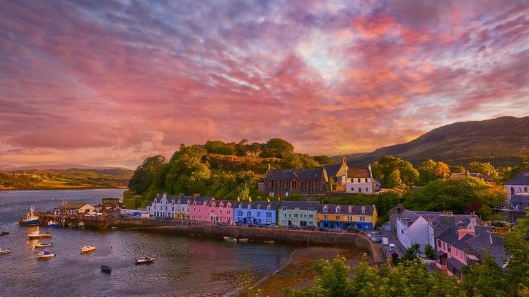 The stunning village of Portree on the Isle of Skye at sunset, home to Scorrybreac Restaurant
