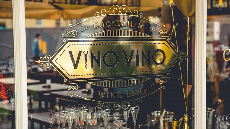 The exterior window of Vino Vino wine bar in Bath