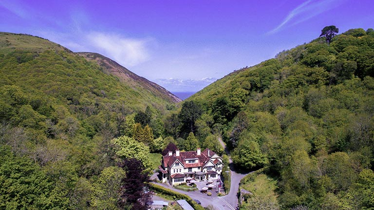 The Hunter's Inn nestled at the bottom of Heddon Valley and surrounded by woods