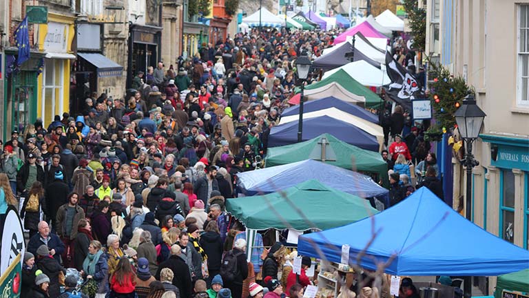 The streets of Glastonbury full of happy shoppers browsing the stalls at the Glastonbury Frost Fayre