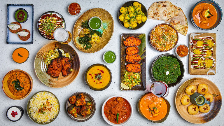 A colourful array of plates of food and spices at Dastaan Indian restaurant in Epsom, Surrey 
