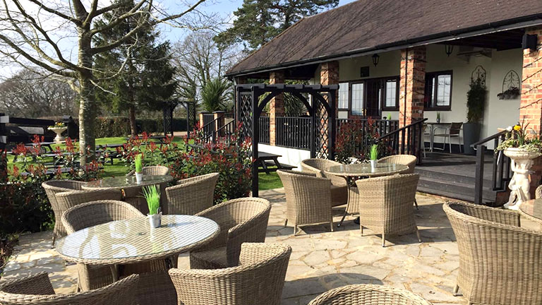 Outdoor tables and chairs at the Grumpy Mole pub near Staffhurst Wood, Oxted