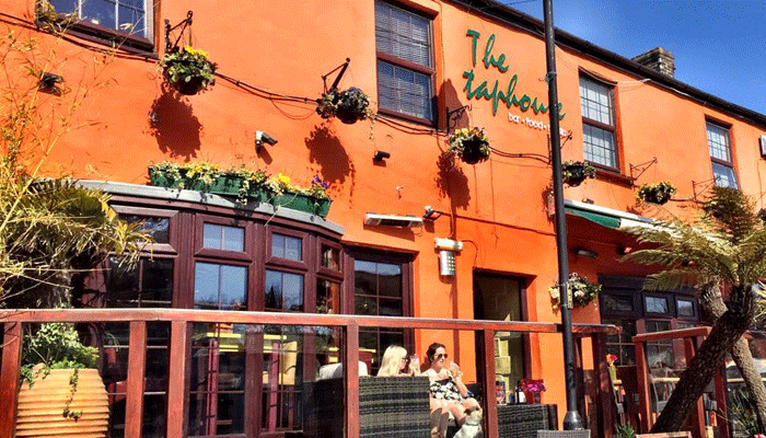 The orange façade of The Taphouse bar and restaurant in St Agnes