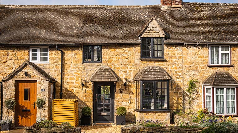 The honey-coloured facade of Number 36 in Broadway, The Cotswolds