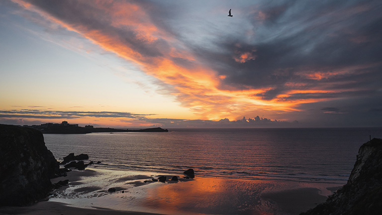 A beautiful sunset painting the sky over Lusty Glaze beach in Newquay