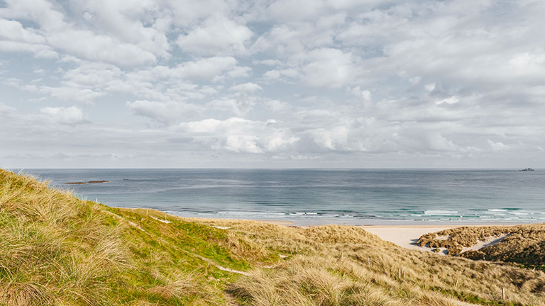 A view over the dunes towards the glittering waters of Sennen Cove