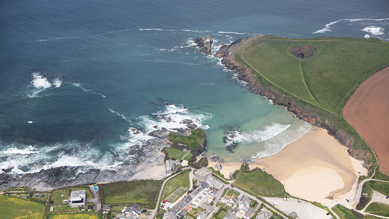 An aerial view of Trevone Bay with the Round Hole in the cliffs