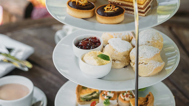 A three-tiered afternoon tea served with sweets, savouries and scones at Meudon in Falmouth