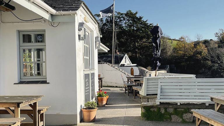 The sunny outside patio of The Ferry Boat Inn in Helford