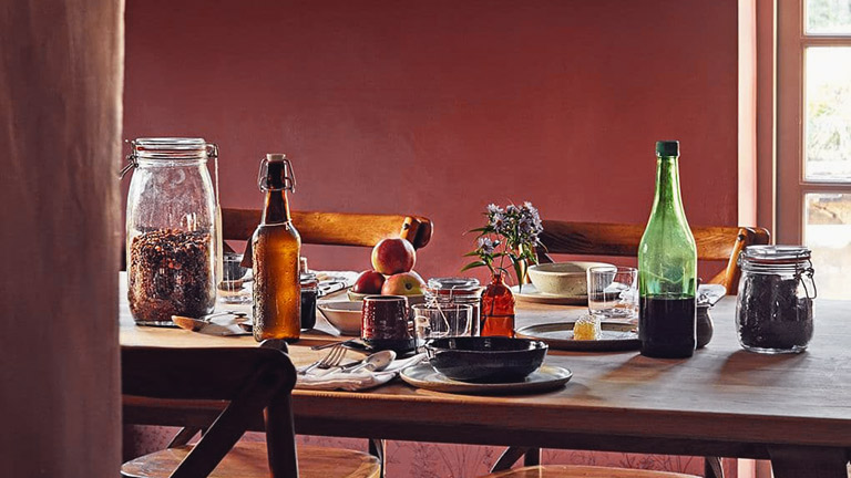 A table laid with cutlery, plates and bottles at Coombeshead Farm, Lewannick