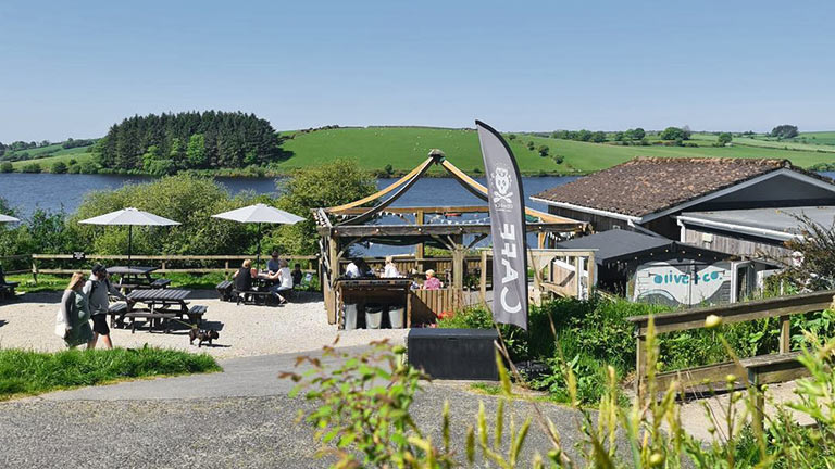 A view of Olive & Co. cafe with Siblyback Lake behind in Cornwall