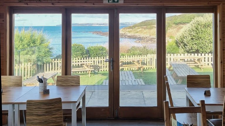 The views from the inside of The Cabin Cafe towards Perranuthnoe's beach and the sea