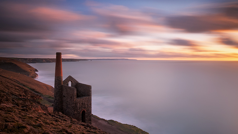 A view of one of the old engine houses at sunset at Wheal Coates near St Agnes