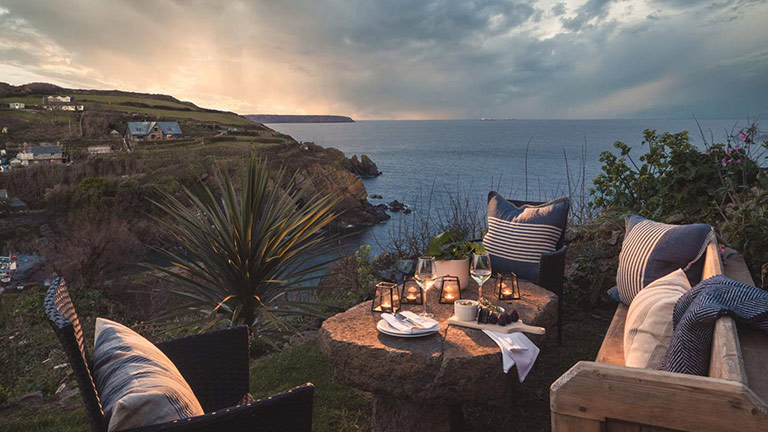 The beautiful outdoor seating area of Atlinto overlooking Cadgwith Cove