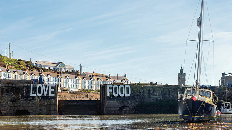 The famous Love Food sign across Porthleven Harbour