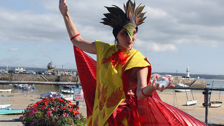A performer dressed as a phoenix during St Ives September Festival