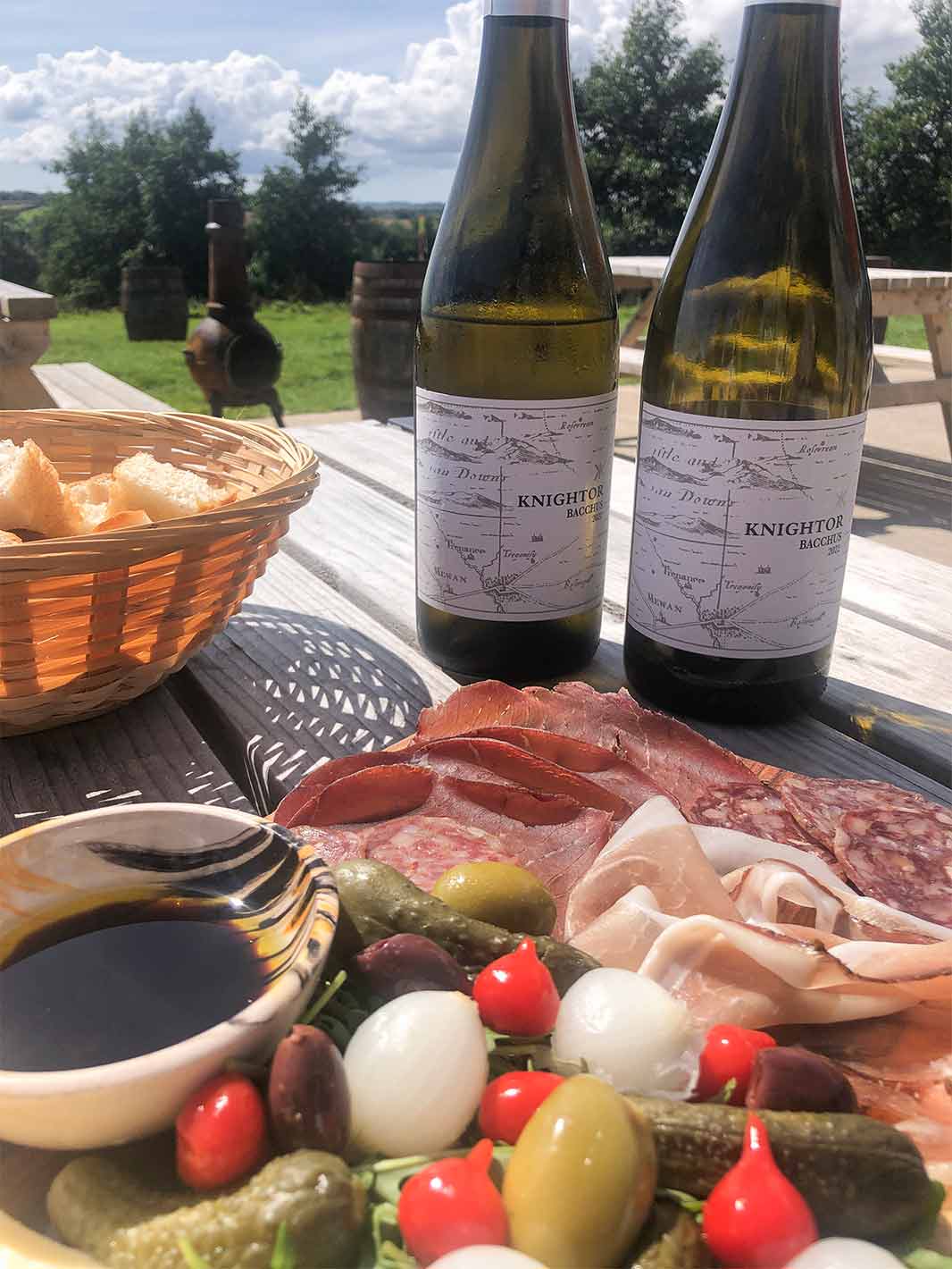Bottles of Knightor wine and a charcuterie spread at Knightor Vineyard in Portscatho, the Roseland