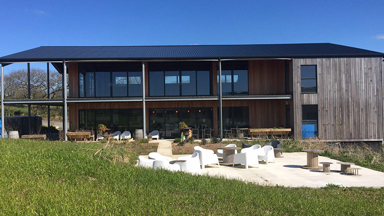 The wood-clad exteriors of Trevibban Mill Vineyard in Padstow