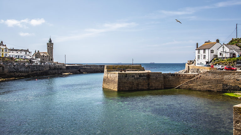 Porthleven's harbour with turquoise waters on a sunny day