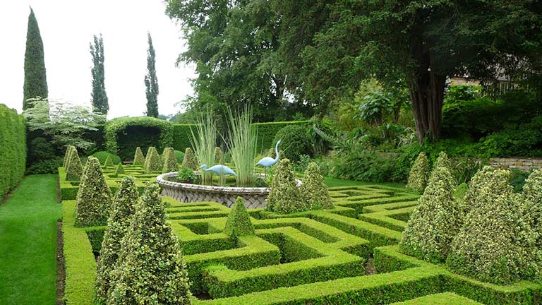 The beautiful knot garden with maze-like hedges at Bourton House Garden in the Cotswolds