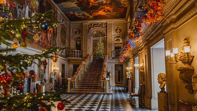 The inside of Chatsworth House at Christmas time adorned with pretty decorations 
