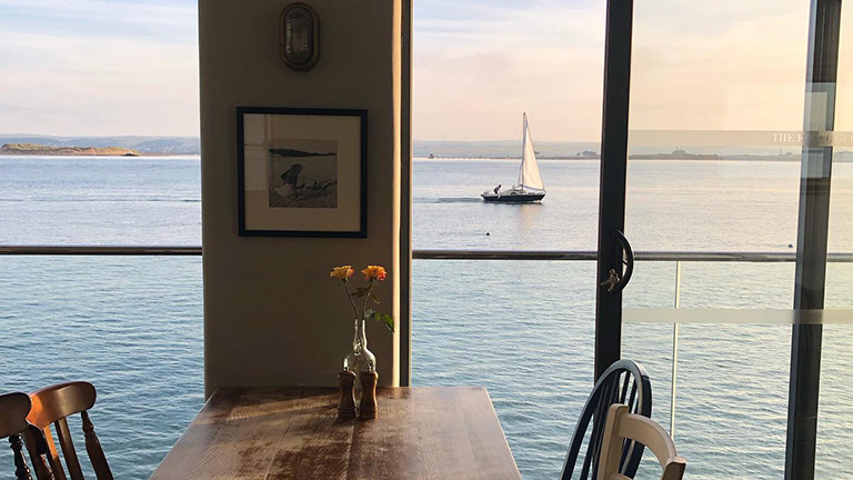 A table and chairs overlooking the water at The Royal George in Appledore