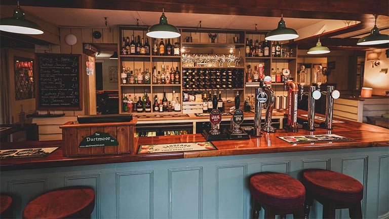 The cosy, eggshell blue bar at The Dartmoor Inn in Devon